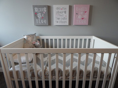 Baby's room crib nursery with canvas prints