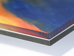 A plexi face mount consists of a photographic print sandwiched between aluminium and plexiglass 