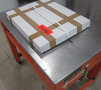 A strapping maching ensures heavy packages are secure and makes them easier to carry