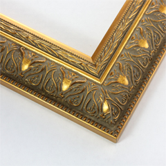 Ornate 2 1/2 " frame with a beaded exterior ridge and a delicate leaf pattern across the face. The design is filled with a matte grey patina and the accents are a vibrant red gold. The profile and inner border are solid, brush red gold.